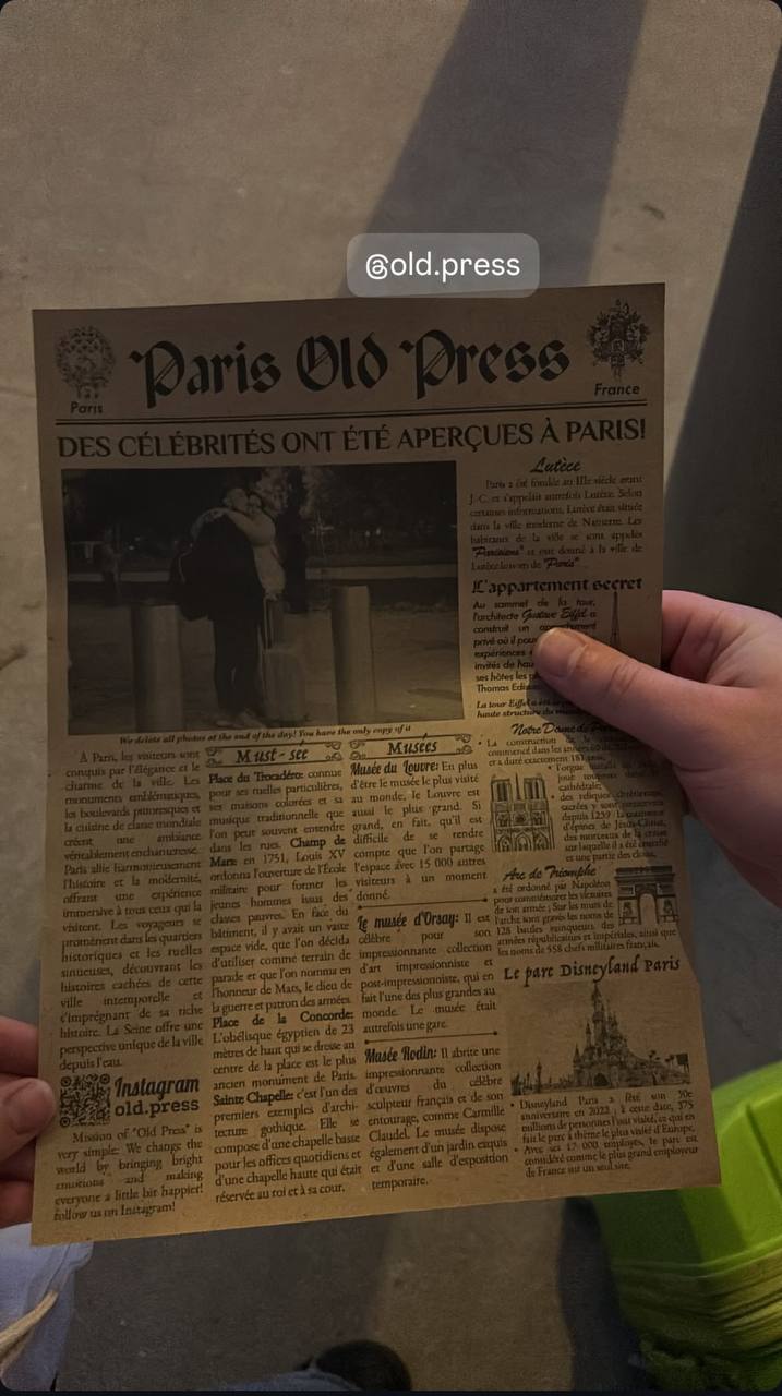 Paris Old Press newspaper held on a Paris street